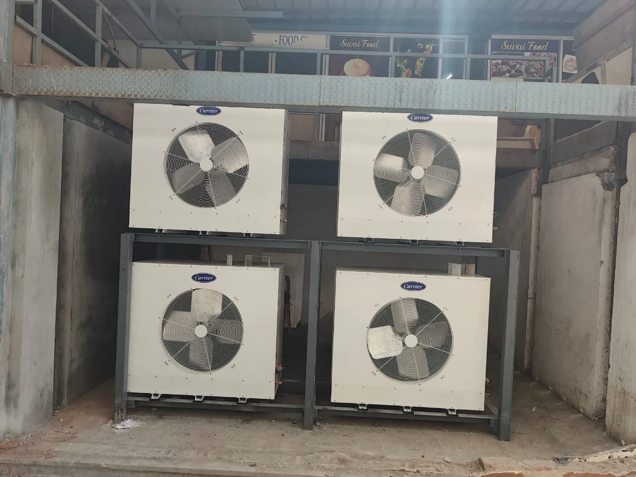 Outdoor condenser units installed on an elevated structural frame